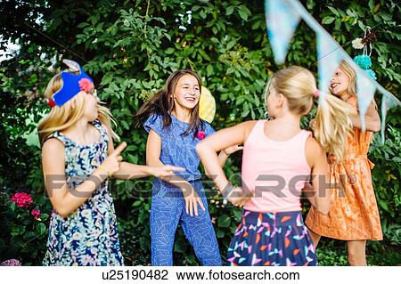 Girls dancing at summer garden party View Large Photo Image Stock Image - Girls dancing at summer garden party. Fotosearch