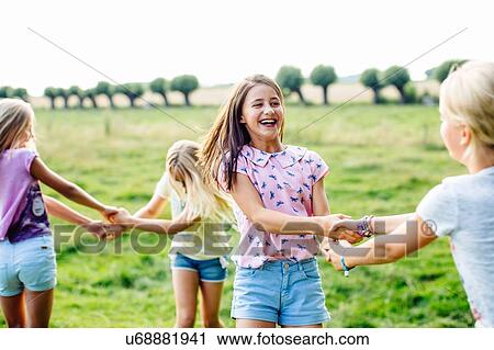 Girls dancing on field, Flanders, Belgium View Large Photo Image Stock Image - Girls dancing on field, Flanders, Belgium. Fotosearch