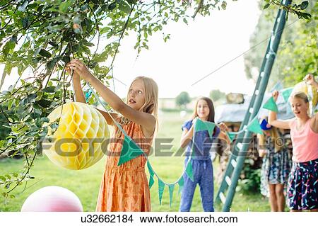Girls decorating garden for summer party View Large Photo Image Picture - Girls decorating garden for summer party. Fotosearch