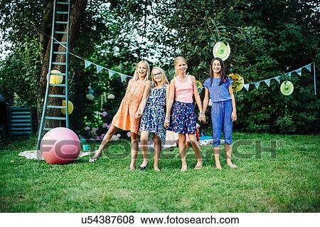 Girls decorating garden for summer party View Large Photo Image Stock Photo - Girls decorating garden for summer party. Fotosearch