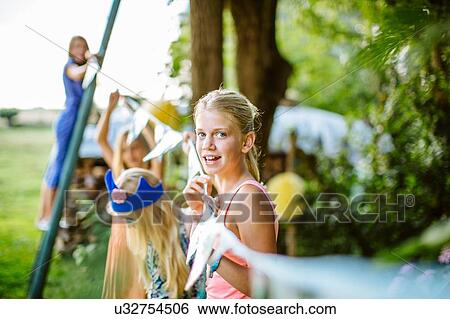 Girls decorating garden for summer party View Large Photo Image Stock Photograph - Girls decorating garden for summer party. Fotosearch
