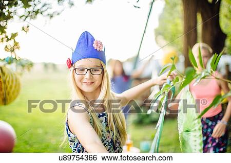 Stock Photograph - Girls decorating garden for summer party. Fotosearch