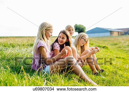 Girls enjoying view in field, Flanders, Belgium View Large Photo Image Picture - Girls enjoying view in field, Flanders, Belgium. Fotosearch