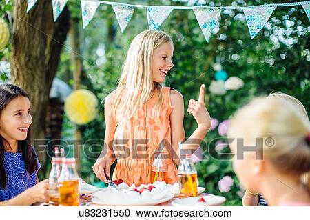 Girls having fun at summer garden party View Large Photo Image Stock Image - Girls having fun at summer garden party. Fotosearch