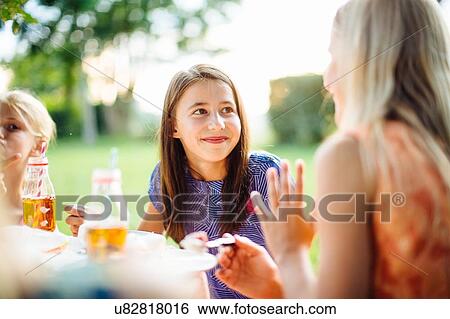 Stock Photograph - Girls having fun at summer garden party. Fotosearch