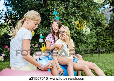 Stock Photography - Girls having fun at summer party. Fotosearch