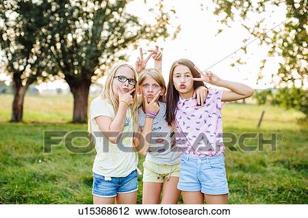 Girls posing, making faces and hand gestures View Large Photo Image Stock Image - Girls posing, making faces and hand gestures. Fotosearch
