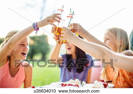 Girls toasting at summer garden party View Large Photo Image Stock Image - Girls toasting at summer garden party. Fotosearch