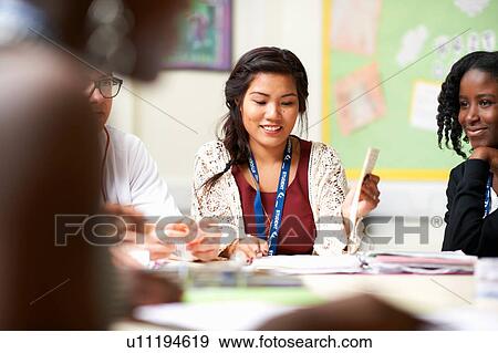 Stock Photo - Group of students teamworking in class. Fotosearch