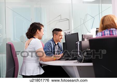 Stock Photograph - Group of students working together in computer class. Fotosearch