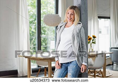 Happy full term pregnancy young woman in kitchen View Large Photo Image Stock Image - Happy full term pregnancy young woman in kitchen. Fotosearch