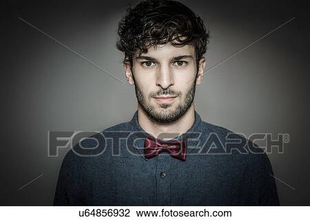 Head and shoulder studio portrait of bearded young man wearing bow tie View Large Photo Image Stock Image - Head and shoulder studio portrait of bearded young man wearing bow tie. Fotosearch