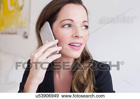 Head and shoulders of mature woman using smartphone looking away View Large Photo Image Stock Photo - Head and shoulders of mature woman using smartphone looking away. Fotosearch