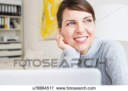Head and shoulders of mature woman with hand on chin looking away smiling View Large Photo Image Stock Photo - Head and shoulders of mature woman with hand on chin looking away smiling. Fotosearch