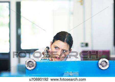 Head and shoulders of young woman operating machine View Large Photo Image Stock Image - Head and shoulders of young woman operating machine. Fotosearch
