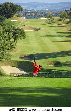 High angle view of golf course and golfer taking golf swing View Large Photo Image Stock Image - High angle view of golf course and golfer taking golf swing. Fotosearch