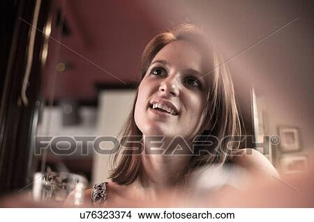 Low angle view of young woman in conversation in traditional pub View Large Photo Image Picture - Low angle view of young woman in conversation in traditional pub. Fotosearch