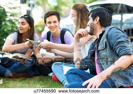 Male and female students sitting chatting on college campus View Large Photo Image Stock Image - Male and female students sitting chatting on college campus. Fotosearch