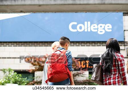 Stock Photography - Male and female students strolling on college campus. Fotosearch
