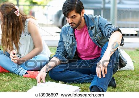 Stock Photo - Male student sitting working on college campus. Fotosearch