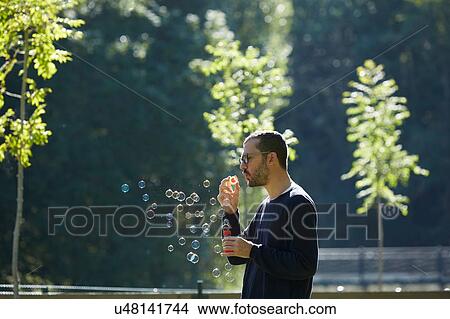 Man blowing bubbles, Valle de Aran, Spain View Large Photo Image Picture - Man blowing bubbles, Valle de Aran, Spain. Fotosearch