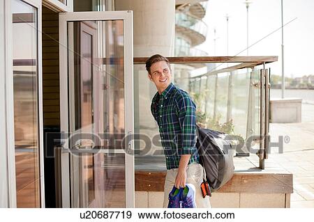 Stock Photo - Man entering sports centre, Wapping, London. Fotosearch