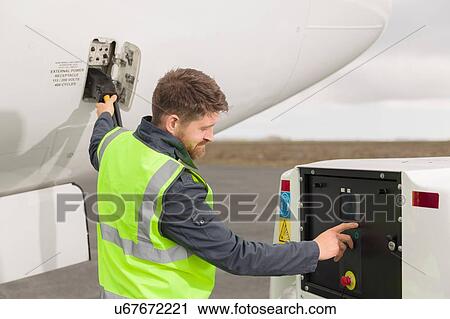 Man wearing high visibility jacket working on airplane on runway View Large Photo Image Stock Image - Man wearing high visibility jacket working on airplane on runway. Fotosearch
