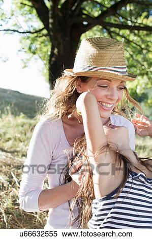 Mature woman and daughter playing in park View Large Photo Image Stock Photography - Mature woman and daughter playing in park. Fotosearch