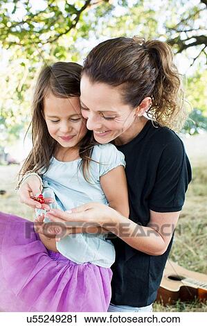 Mature woman and daughter sitting in park eating redcurrants View Large Photo Image Stock Image - Mature woman and daughter sitting in park eating redcurrants. Fotosearch