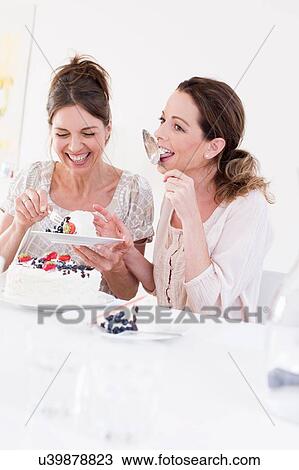 Mature woman eating cake, licking cake server smiling View Large Photo Image Stock Image - Mature woman eating cake, licking cake server smiling. Fotosearch