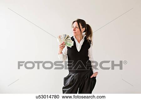 Mature woman, fanning herself with money View Large Photo Image Stock Image - Mature woman, fanning herself with money. Fotosearch