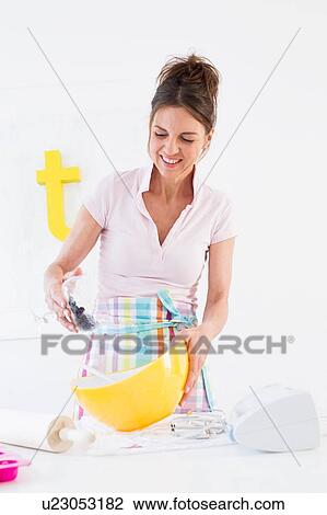 Mature woman pouring blueberries into yellow mixing bowl View Large Photo Image Stock Image - Mature woman pouring blueberries into yellow mixing bowl. Fotosearch