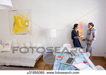 Mature women at home leaning against wall talking View Large Photo Image Stock Photography - Mature women at home leaning against wall talking. Fotosearch
