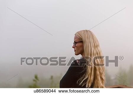 Picture - Mid adult woman looking at view, outdoors. Fotosearch