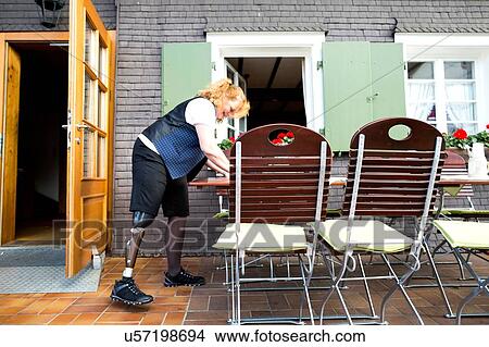 Mid adult woman with prosthetic leg, on patio View Large Photo Image Picture - Mid adult woman with prosthetic leg, on patio. Fotosearch