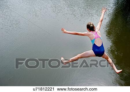 Overhead view of girl jumping into lake View Large Photo Image Stock Image - Overhead view of girl jumping into lake. Fotosearch