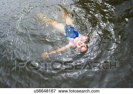 Overhead view of girl swimming in rural lake View Large Photo Image Stock Photo - Overhead view of girl swimming in rural lake. Fotosearch