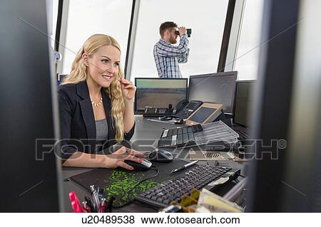 People working in air traffic control tower, monitoring screens and looking through binoculars View Large Photo Image Stock Photo - People working in air traffic control tower, monitoring screens and looking through binoculars. Fotosearch