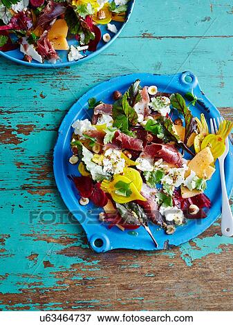 Plate of duck prosciutto salad on rustic table View Large Photo Image Stock Photo - Plate of duck prosciutto salad on rustic table. Fotosearch