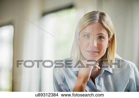 Picture - Portrait of beautiful young woman with chin on hand. Fotosearch