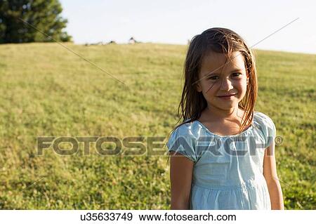 Stock Photo - Portrait of cute girl in park. Fotosearch