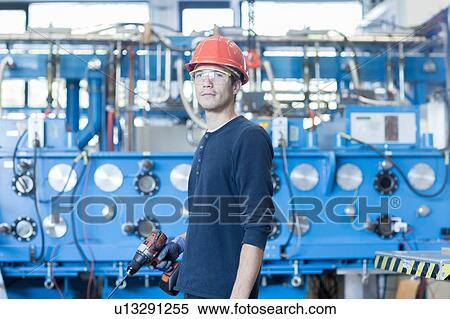 Stock Photography - Portrait of factory engineer and industrial machinery. Fotosearch