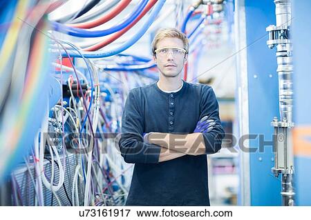 Portrait of factory technician in network room View Large Photo Image Stock Photo - Portrait of factory technician in network room. Fotosearch