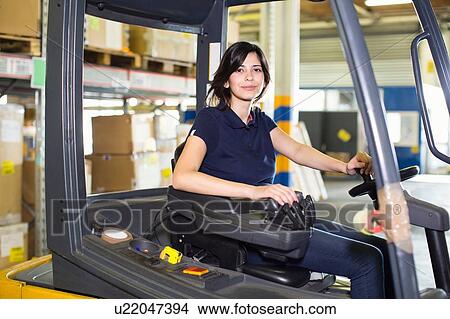 Portrait of female forklift truck driver working in distribution warehouse View Large Photo Image Picture - Portrait of female forklift truck driver working in distribution warehouse. Fotosearch