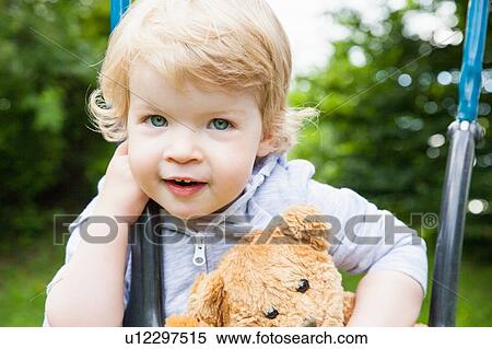 Portrait of female toddler playing on park swing View Large Photo Image Stock Photography - Portrait of female toddler playing on park swing. Fotosearch
