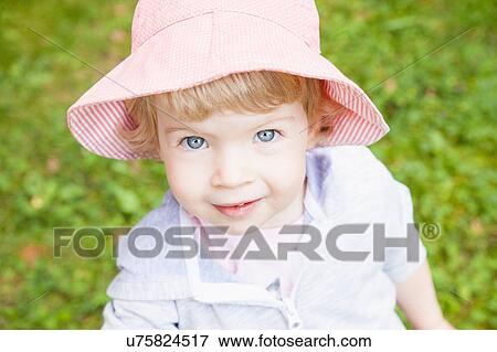 Portrait of female toddler wearing pink sunhat View Large Photo Image Stock Photo - Portrait of female toddler wearing pink sunhat. Fotosearch