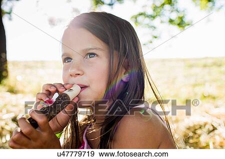 Portrait of girl blowing bird whistle in park View Large Photo Image Stock Photo - Portrait of girl blowing bird whistle in park. Fotosearch