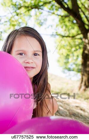 Portrait of girl hiding behind pink balloons in park View Large Photo Image Stock Photography - Portrait of girl hiding behind pink balloons in park. Fotosearch