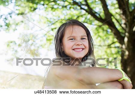 Portrait of girl in sunlit park View Large Photo Image Stock Photo - Portrait of girl in sunlit park. Fotosearch