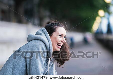 Portrait of happy female runner taking a break on riverside View Large Photo Image Stock Photo - Portrait of happy female runner taking a break on riverside. Fotosearch